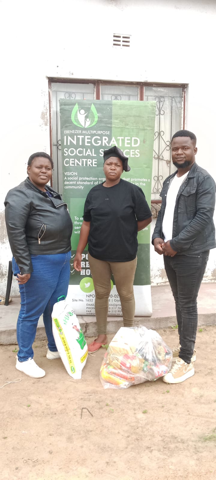 EMISSC team handing a food parcel to a community member